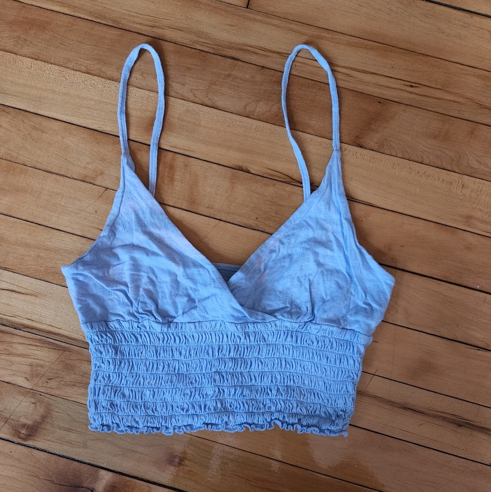 Light blue stretchy crop top with bleach stains